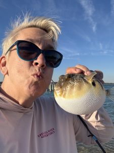 Miss Kay Kisses A Puffer Fish She Just Caught